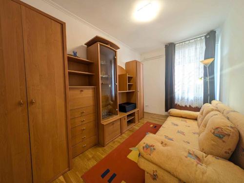 a living room with a couch and a dresser at Apartment in Siofok - Balaton 54329 in Siófok