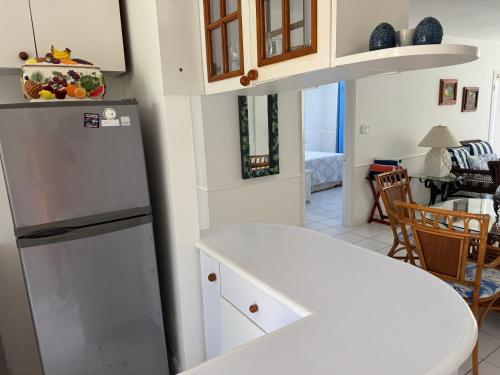 a kitchen with a refrigerator and a dining room at Sunset Cove - Vacation In Paradise! in Nassau