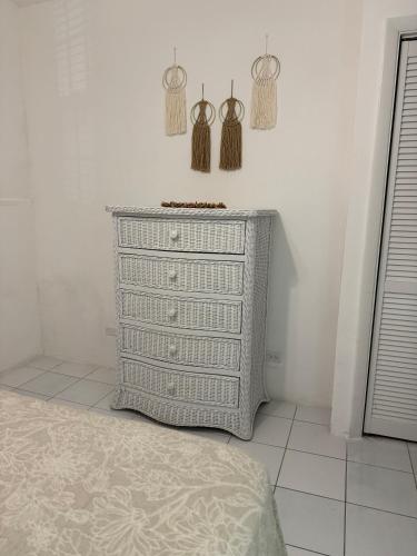 a dresser in a room with hangers on the wall at Sunset Cove - Vacation In Paradise! in Nassau