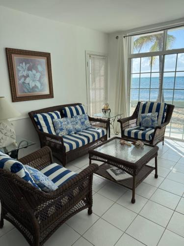 a living room with chairs and a coffee table at Sunset Cove - Vacation In Paradise! in Nassau