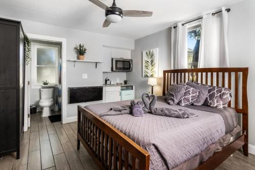 a bedroom with a large bed with purple pillows at Recently Renovated! 3BR 2BA Ybor Bungalow in Tampa