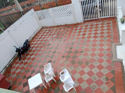 an aerial view of two white chairs and a scooter at Habitación con aire y piscina in Santa Veronica