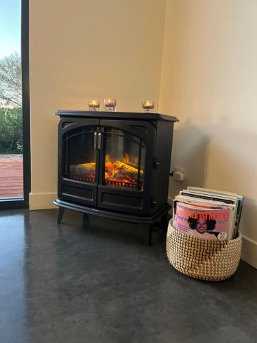 a fireplace in a living room with a fire place at Wharfedale in Wilyabrup