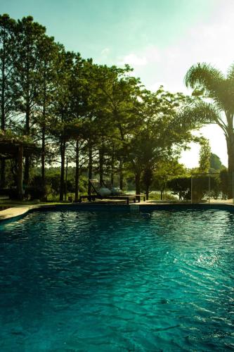 a pool of blue water with trees in the background at Der Hase I in Concordia