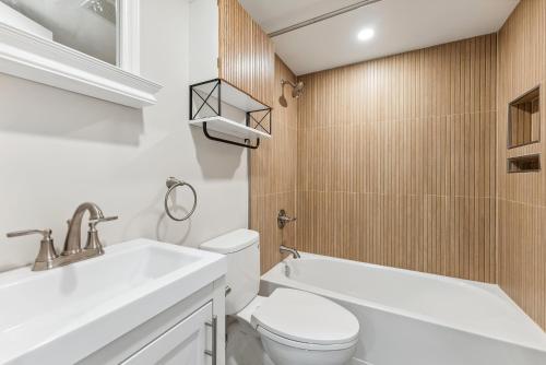 a bathroom with a white toilet and a sink at North Wind Motel in North Wildwood