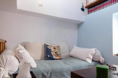 a living room with a couch with pillows at Traditional two floor house 75m2 in Andros