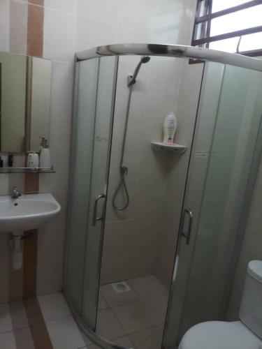 a bathroom with a shower and a sink at Homestay Ipoh Maziah in Ipoh