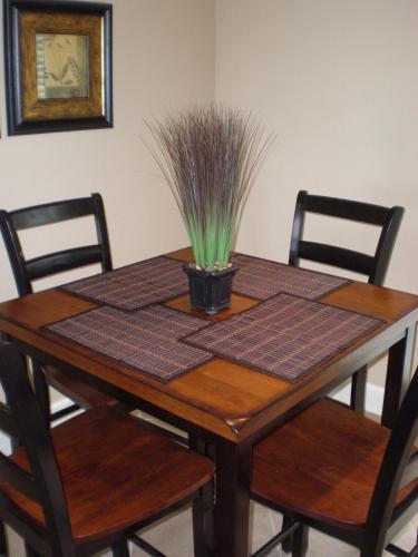 a wooden table with a plant on top of it at 2 Bd, Oceanfront Oasis, Lots of deals and Winter Texans book early in Galveston