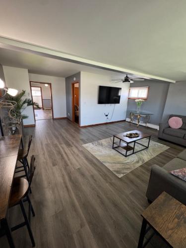 a living room with a couch and a tv at Luxury Villa in Lancaster