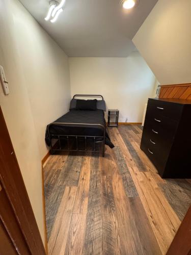 a bedroom with a bed and a dresser in it at Luxury Villa in Lancaster
