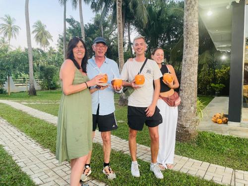 a group of people posing for a picture with pumpkins at Tranquil Sanctuary Yala in Tissamaharama