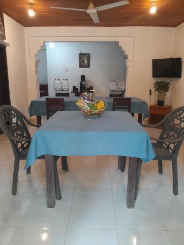 a blue table with a bowl of fruit on it at Eco Leisure Kadugannawa Reach in Mawanella