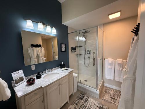 a bathroom with a sink and a shower at 2 Rivers Inn The Thousand Islands - LUXURY WATERFRONT WALKOUT in Gananoque