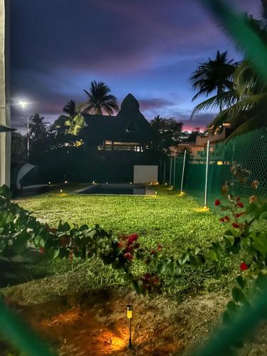 a view of a tennis court at night at Tritón Apartment, ground floor and pool in Barra de Navidad