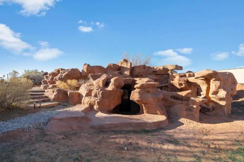 a stone building in the middle of the desert at Cave Dwellers- Zions' Only Hand-Sculpted Cave in Cane Beds