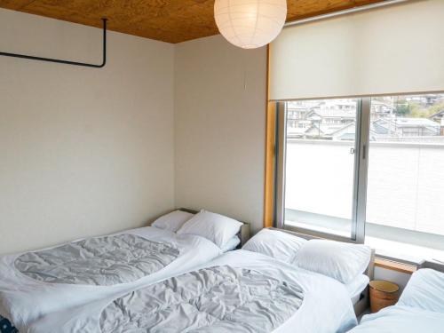Postel nebo postele na pokoji v ubytování Vacation House YOKOMBO ANNEX