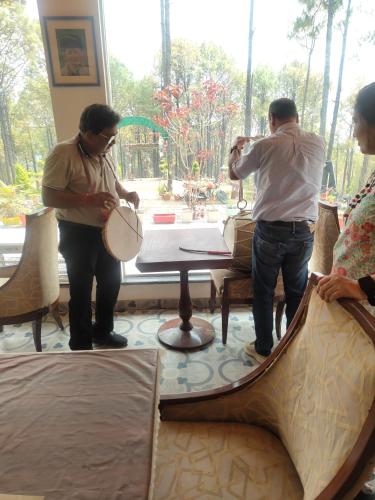 a group of people standing around a table playing drums at In the woods homestay Lansdowne in Lansdowne