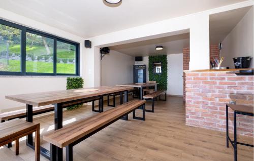 a dining room with wooden tables and benches at Nice Home In Zadrkovec With Wifi in Zadrkovec