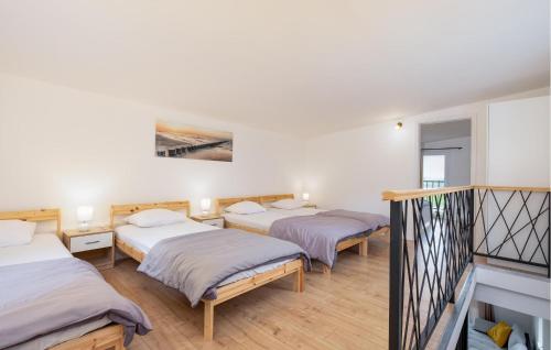 a room with three beds and a staircase at Nice Home In Zadrkovec With Wifi in Zadrkovec