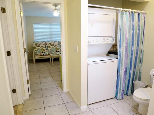 a kitchen with a washer and dryer in a room at Sand Dollar Beach Side Villa in Holmes Beach