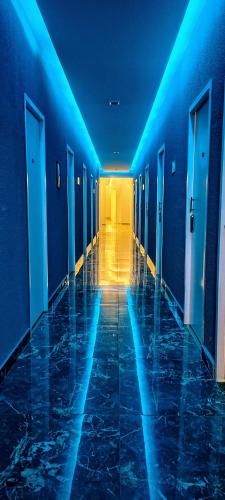 a hallway with blue lights in a building at On Hotel Campos do Jordao centro capivari e Passeio Quadriciclo in Campos do Jordão
