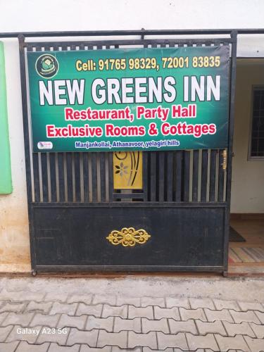 a black garage door with a sign on it at Greens home stay in Yelagiri