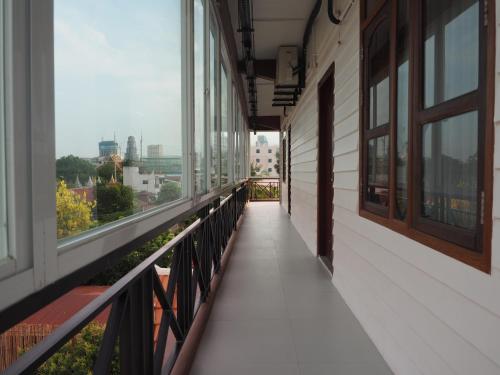 an empty balcony of a building with windows at Activate C3 Hostel in Phnom Penh