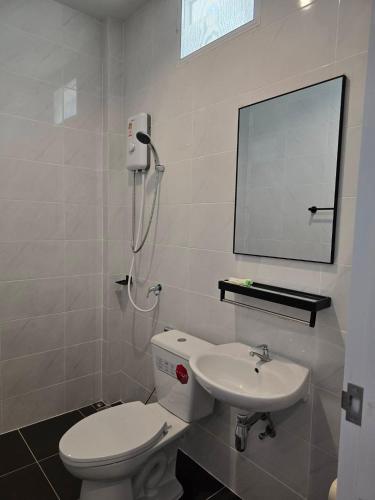a bathroom with a white toilet and a sink at แวะพักสเตย์โฮเทล Wae Phak Stay Hotel in Ban Huai Sai