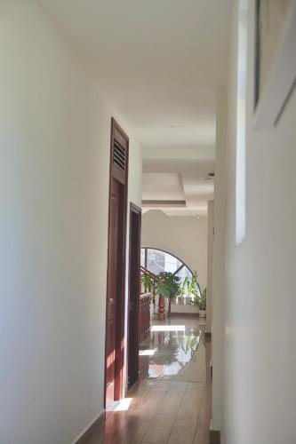 an empty hallway of a building with a door at Ngo - The Gallery Hotel Dalat in Da Thanh