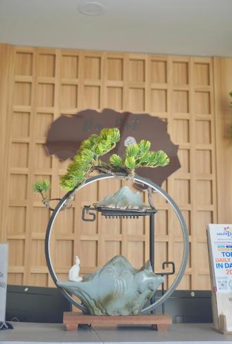 a vase with a pig and a tree on top of it at Ngo - The Gallery Hotel Dalat in Da Thanh
