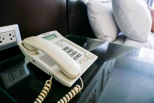 a phone is sitting on a glass table at Apart Hotel Petit Palace Suites in Lima