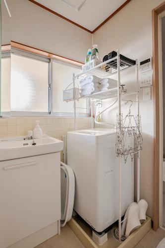 a small kitchen with a sink and a washing machine at okn飛騨高山201 in Takayama
