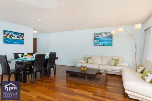 a living room with a couch and a table at Turquoise Ocean Views Walk to Waikiki in Honolulu