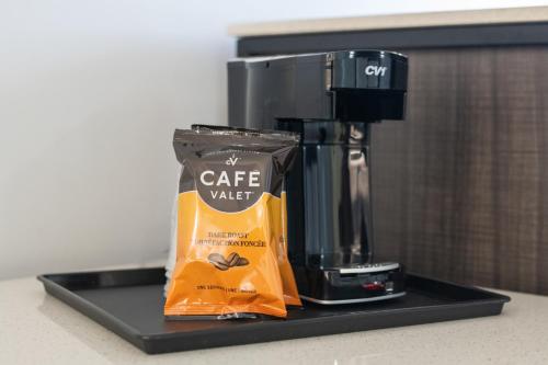 a coffee maker and a bag of coffee on a tray at beach inn motel in Huntington Beach