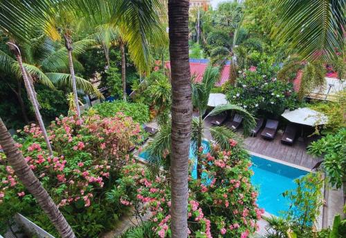 an aerial view of a resort with a swimming pool and palm trees at Angkor Home 27 in Phumĭ Réach Born