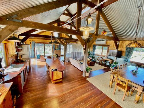 a large living room with wooden floors and wooden ceilings at The Barn at Piney Ridge Farm - Bed & Breakfast in Nairne
