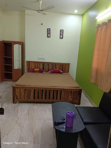 a bedroom with a large bed in a room at Greens home stay in Yelagiri