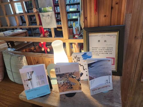 a table with boxes on it with a lamp on it at Eternal Seaside House in Nangan