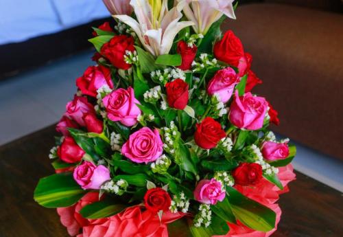 a bouquet of red and pink roses and other flowers at Angkor Home 27 in Phumĭ Réach Born
