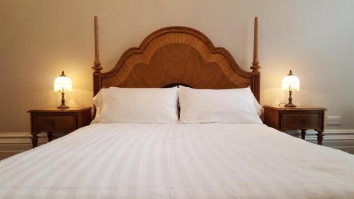 a large bed with two lamps on two night stands at Red Brighton Blue in Brighton & Hove