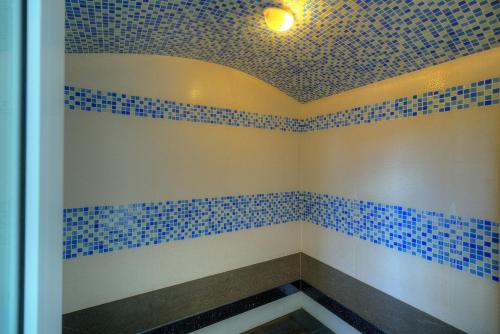 a room with blue tiled walls and a ceiling at Orussey One Hotel & Apartment in Phnom Penh