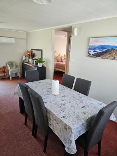 a dining room with a table and chairs at On Tate in Waitara