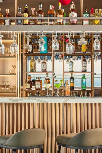 a bar with two chairs in front of a counter at PANAMA Nha Trang Hotel in Nha Trang