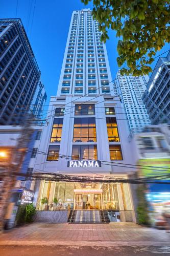 a building with a panama sign on the front with tall buildings at PANAMA Nha Trang Hotel in Nha Trang