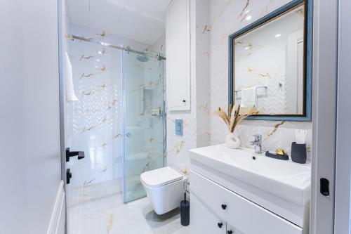 a bathroom with a toilet and a sink and a shower at Sunset Apart-Hotel in Yerevan