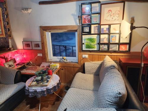 a living room with two couches and a table at Eternal Seaside House in Nangan