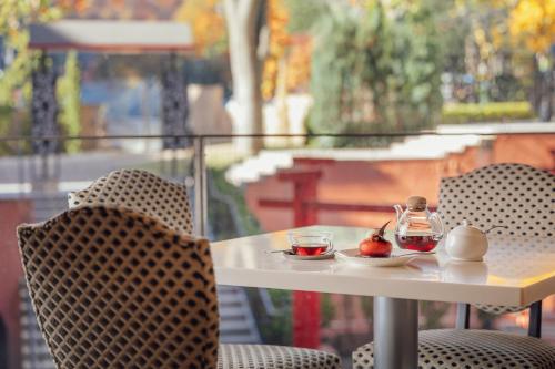 a table and chairs with a tea set on it at Kokusai 21 International Hotel in Nagano