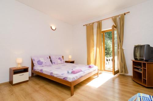 Ένα ή περισσότερα κρεβάτια σε δωμάτιο στο Apartments Limuni