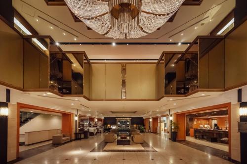 a lobby of a hotel with a large chandelier at Kokusai 21 International Hotel in Nagano