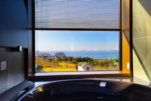 a window in a room with a view of the ocean at Gold Valley Villa A in Futtsu